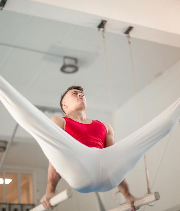 Man performing a controlled strength exercise in a calm, focused environment.