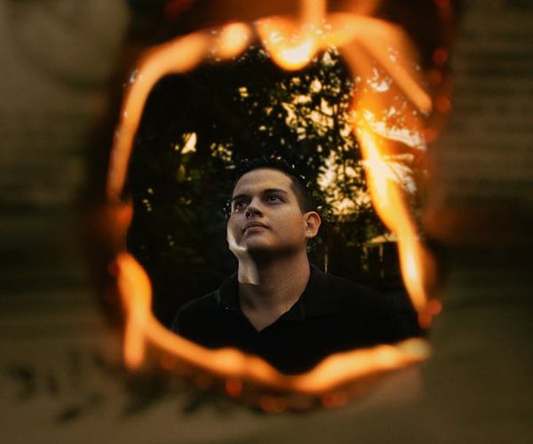 Silhouette of a man stretching against a sunrise, symbolizing energy and focus.